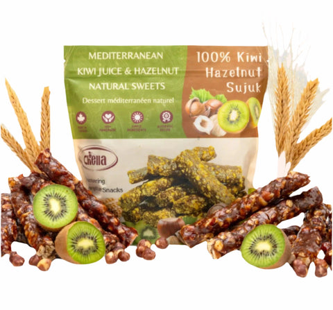 Package of Chella FruityNuts Bar kiwi and hazelnut flavour surrounded by clusters of shiny bars and wheat stalks on a white background.