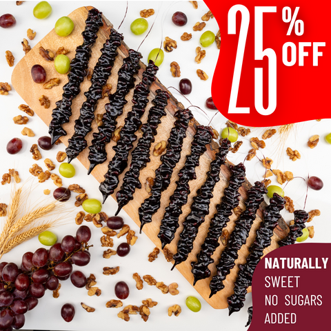 Assortment of 12 grapes churchkhelas on a wooden board, surrounded by walnuts, grapes, and wheat on a white background. Red tags display '25% off'