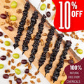 Six Churchkhelas lie on a wooden board surrounded by grapes, wheat and walnuts. A red banner announces "10% off".