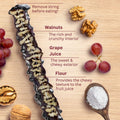 Cross-section of a walnut churchkhela with labeled parts: walnuts for crunch, sweet grape juice exterior, and flour for texture, shown with grapes and walnuts.