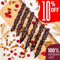 Six Churchkhelas lie on a wooden board surrounded by raspberries, wheat and walnuts. A red banner announces "10% off" and "100% raspberry juice."